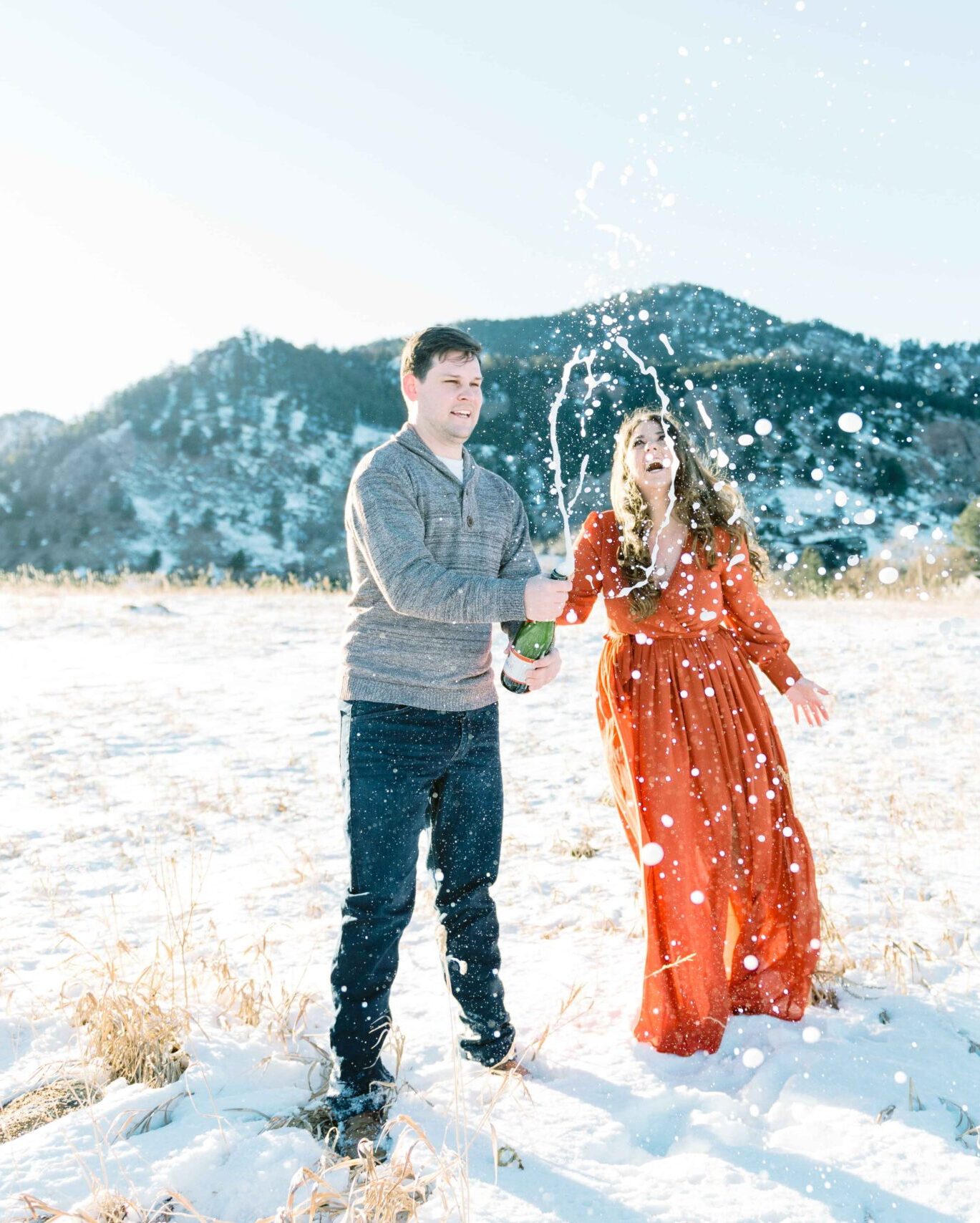 engaged colorado couple in boulder with champagne picture by hillary moore wedding photography