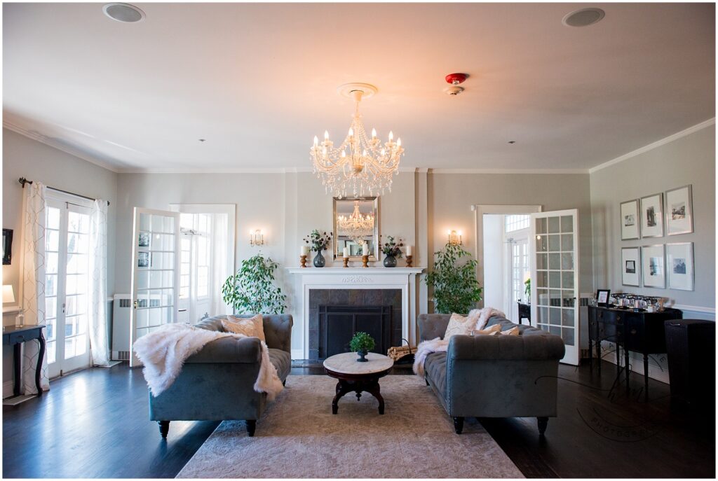 Couches facing each other in front of a fire place in a room within the reception area.