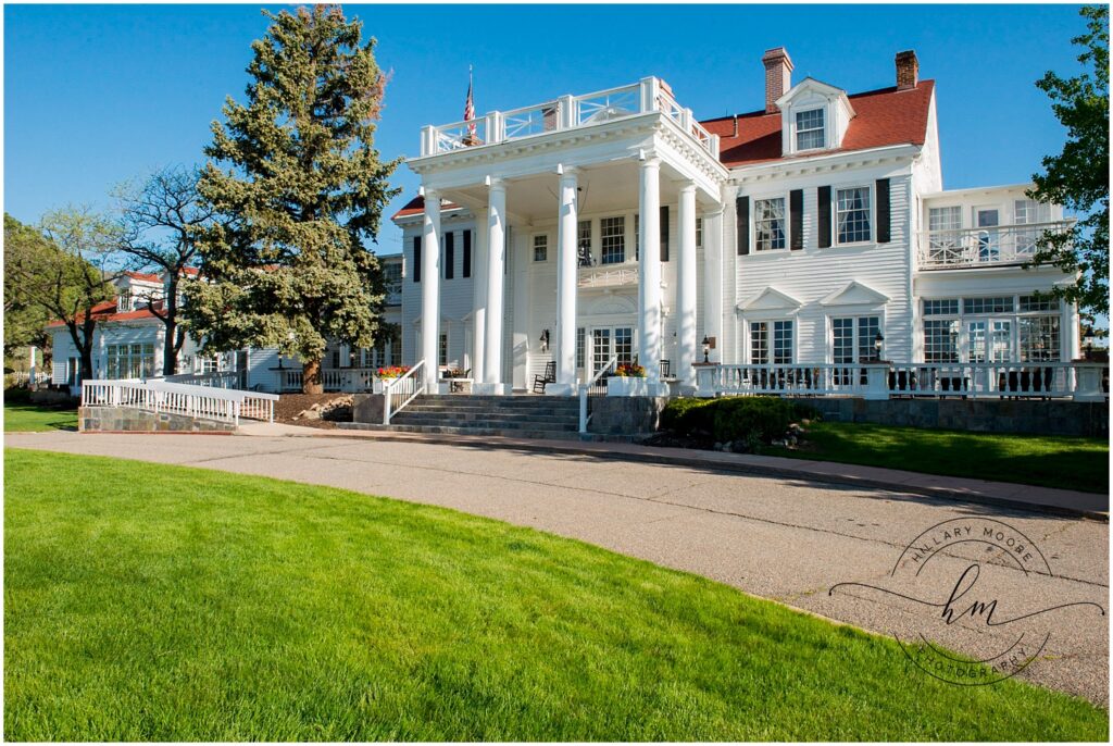 Large white house with pillars in front.