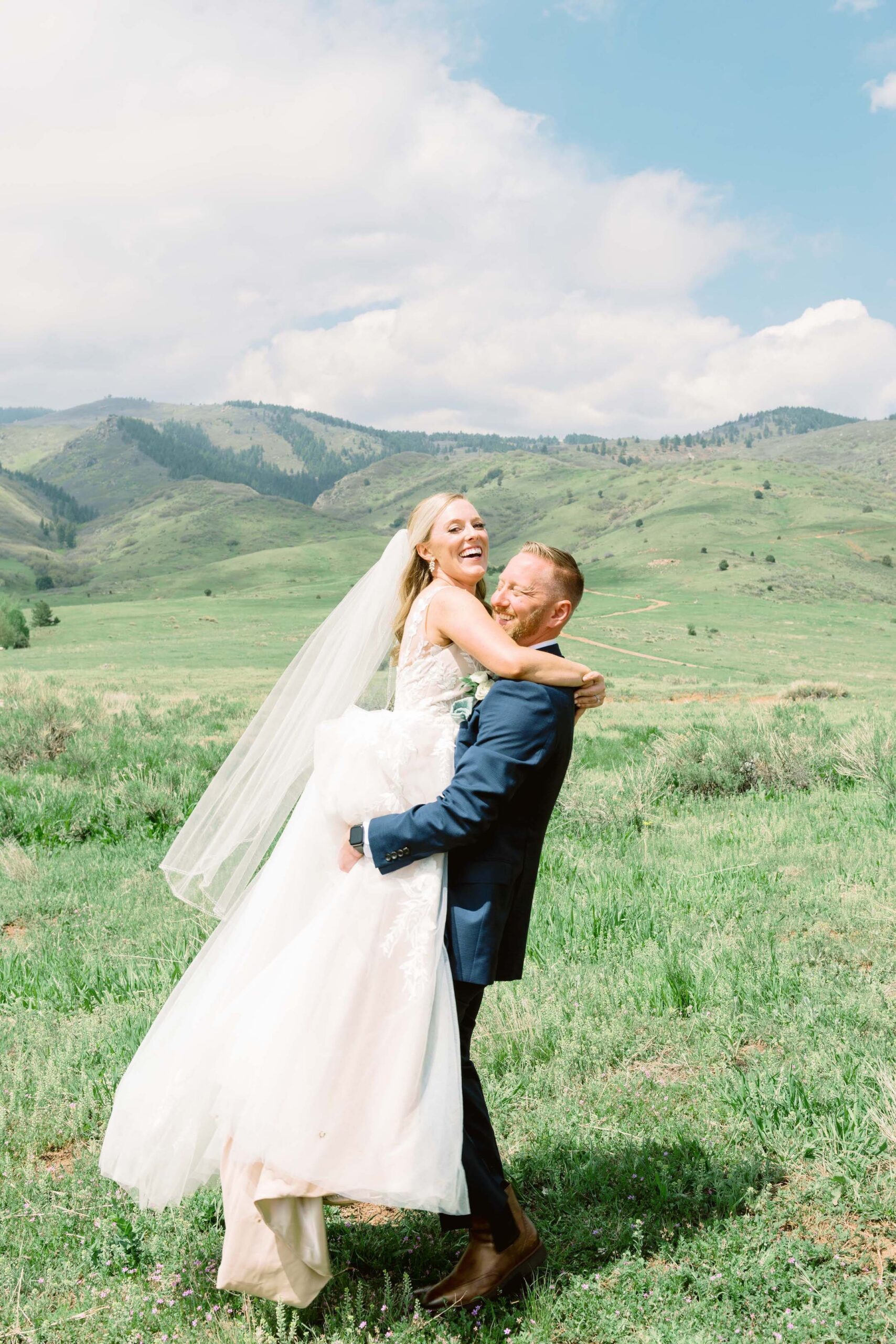 bride and groom on grassy hill