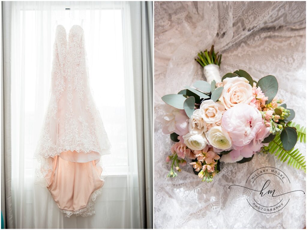 Dress hanging in a window and a bouquet of flowers.