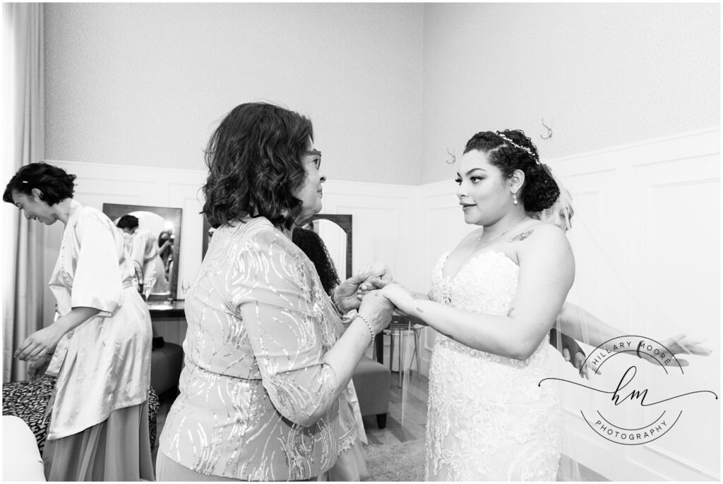 Bride holding hands with a woman.