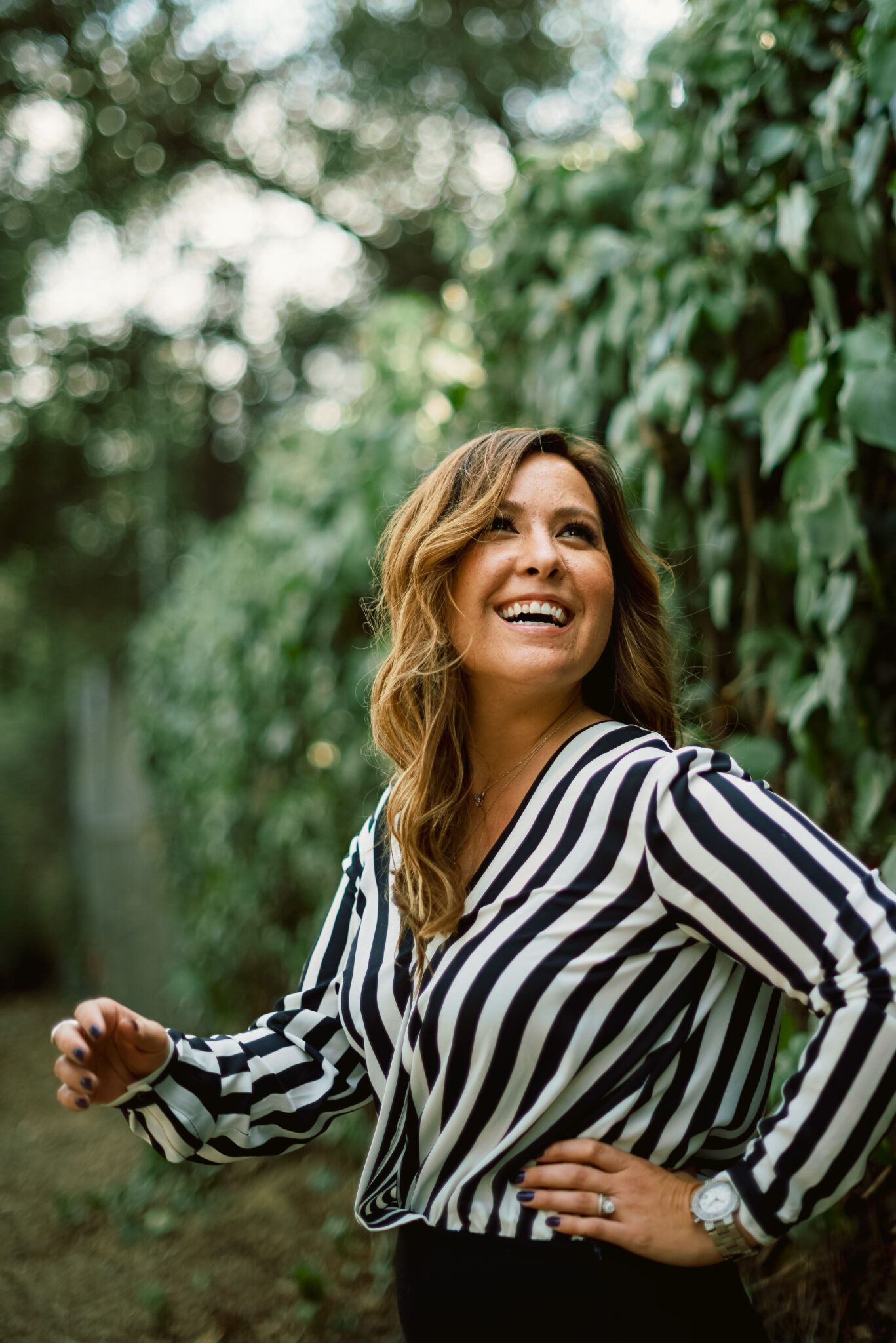 photographer hillary moore in a black and white top smiling 