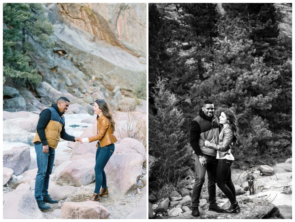 couple smiling while standing on rocks