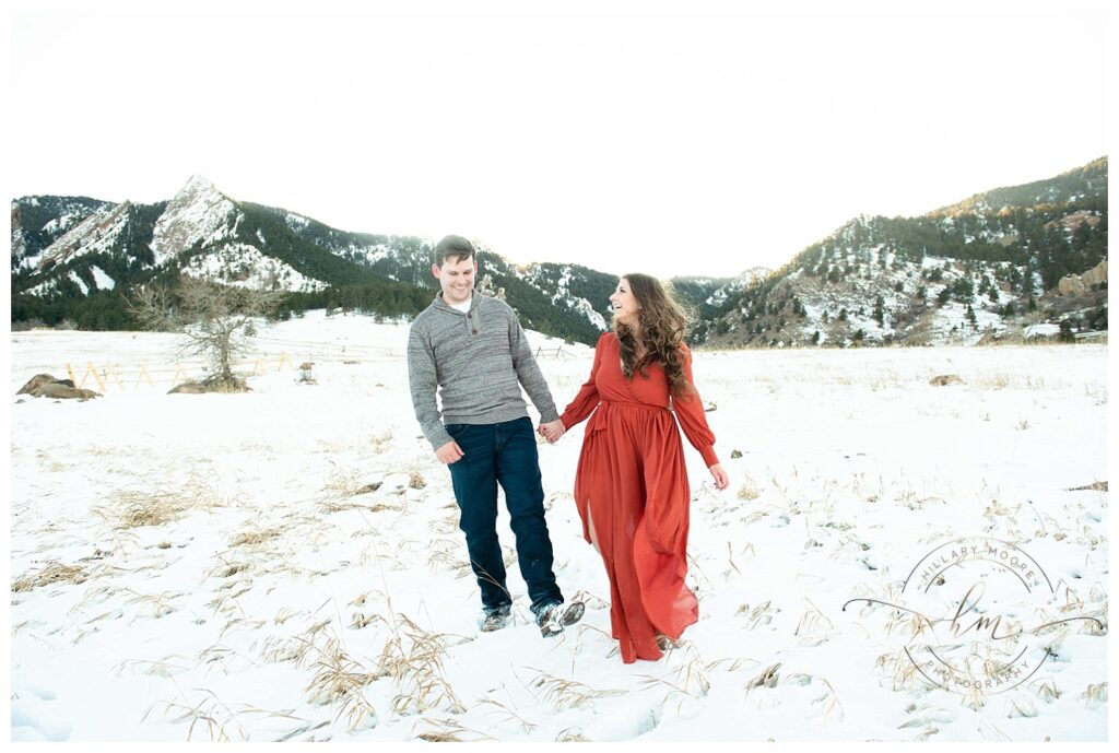 couple walking in snowy field