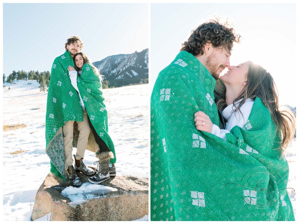 couple posing while wrapped in green blanket