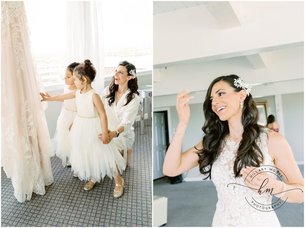 The left photo is of the bride knelt down next to the two flower girls as they all admire the brides hanging wedding dress.