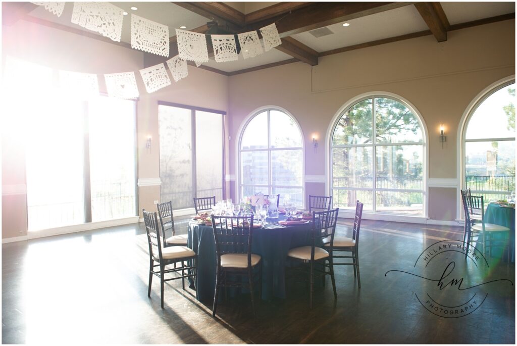 The sun shining on a set table in the wedding reception hall.