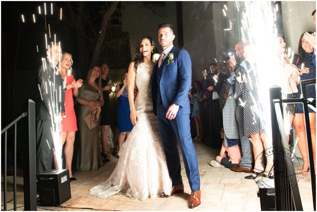 Couple standing with pyrotechnics after getting married